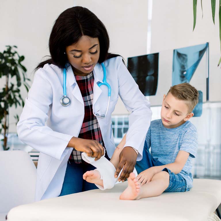 Young podiatrist with child patient