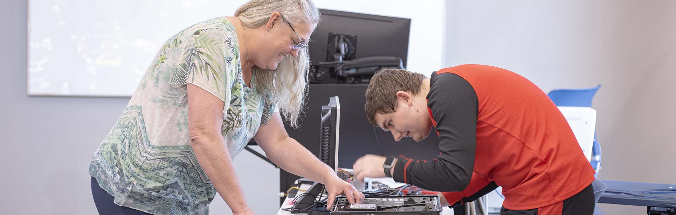 Professor and student working on computers