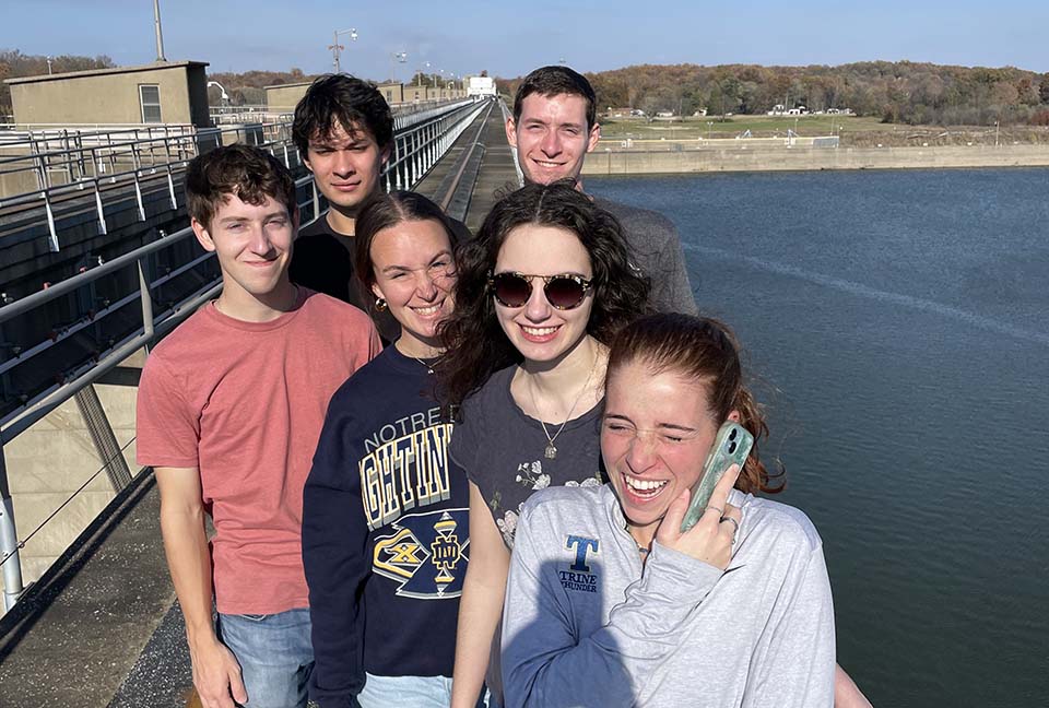 Trine University civil engineering students standing on dam