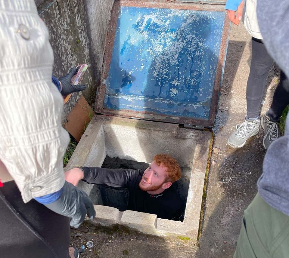 Trine student taking measurements in water storage tank