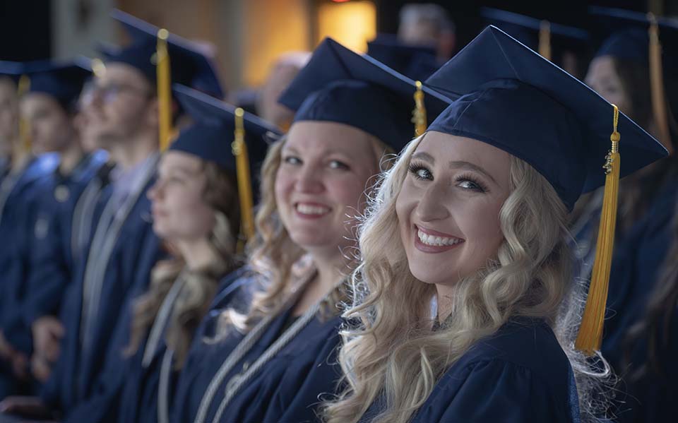 Smiling graduates at Commencement