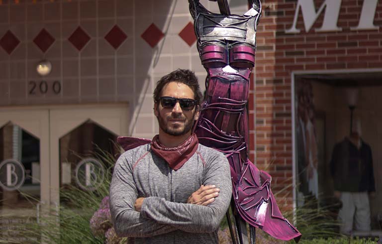 Greg Mendez with sculpture