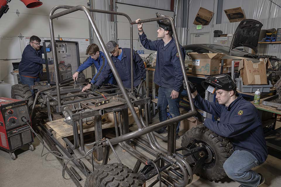 Hydro excavation vehicle with students working