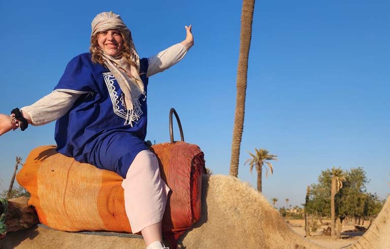 Mackenzie Rosenau on a camel in Morocco