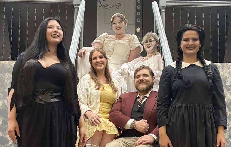 Cast from The Addams Family in costume as Morticia, Alice and Mal Beineke, Ancestors and Wednesday.