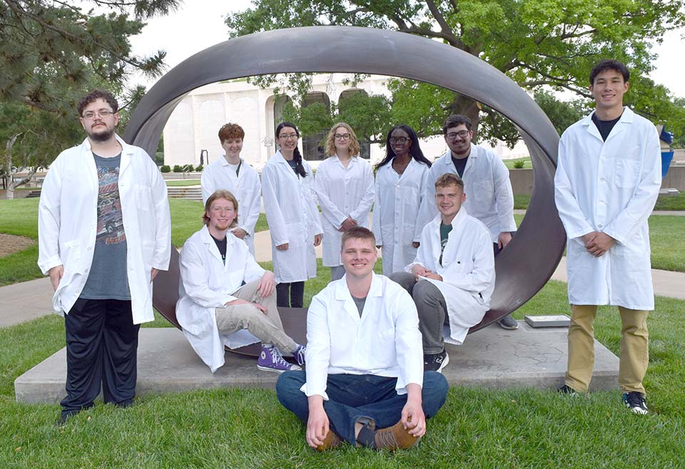 Students around campus sculpture