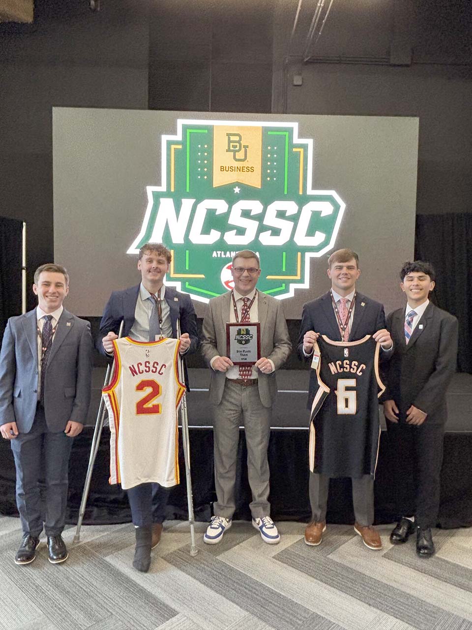 Students and faculty with plaque and jersey awards from NCSSC