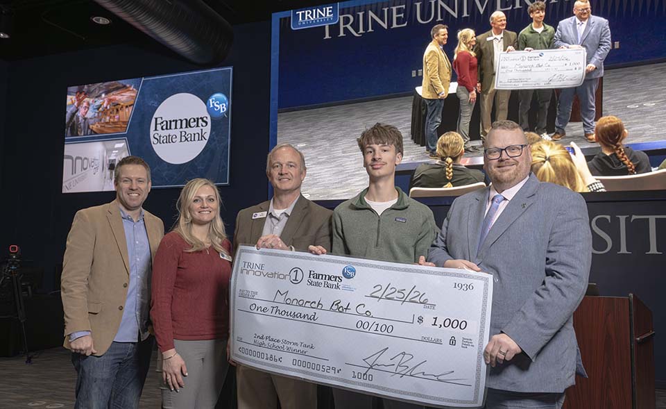 Three Farmers State Bank executives, high school student and Jason Blume with large check