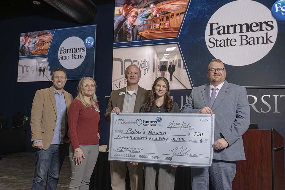 Three Farmers State Bank executives, high school student and Jason Blume with large check