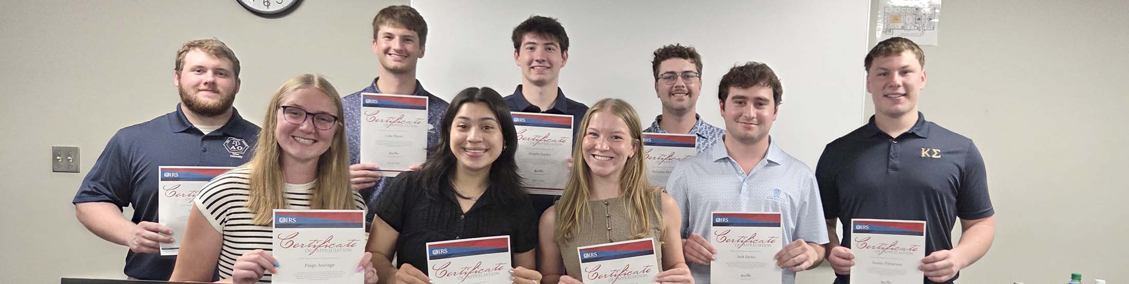 Nine students holding VITA certificates