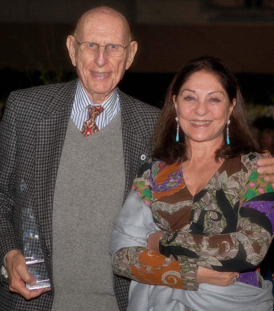 Dr. Tomas Furth holding award, with his arm around his wife Ema